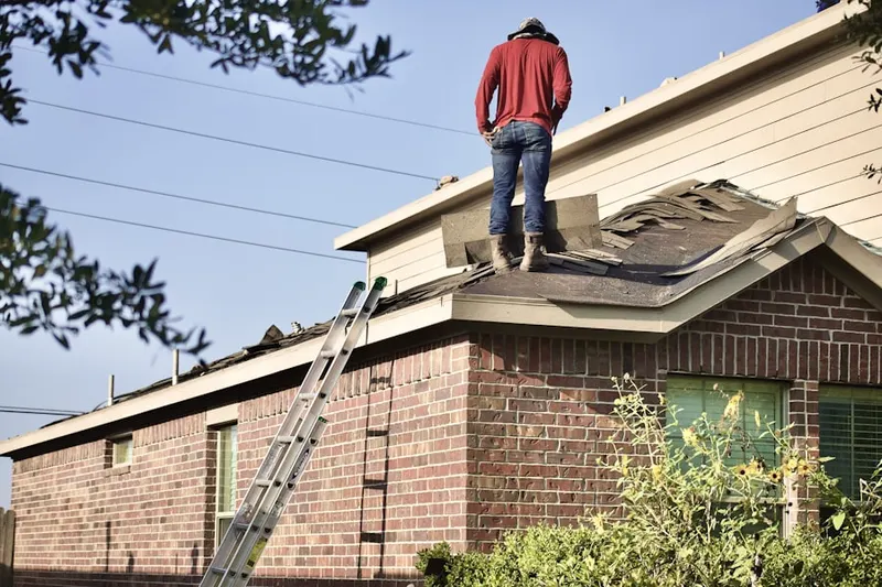 Professional roofer working on a residential roof in The Pines